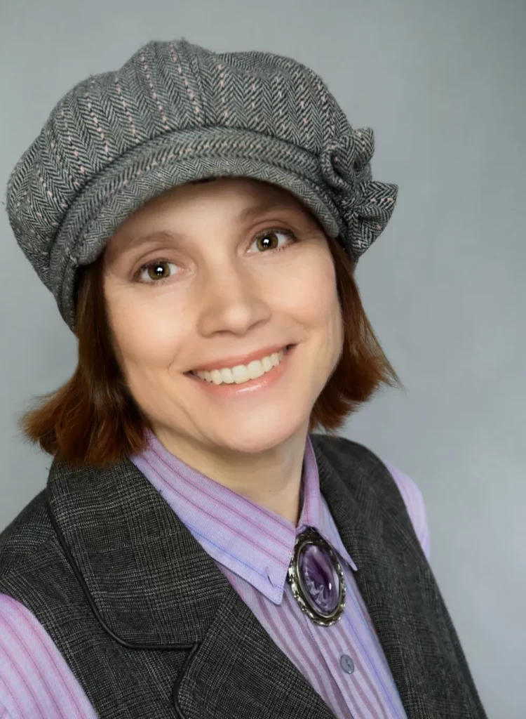 Michèle Laframboise smiling at the camera, wearing a cute hat